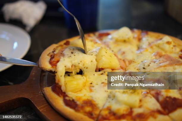 pizza hawaiian on top with ham, bacon, pineapple and pizza sauce cheese in paper box, food background - hawaiian pizza stock pictures, royalty-free photos & images