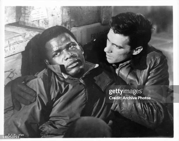 Sidney Poitier is supported by John Cassavetes in a scene from the film 'Edge Of The City', 1957.