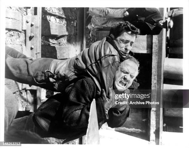 John Cassavetes and Jack Warden grapple furiously in a scene from the film 'Edge Of The City', 1957.