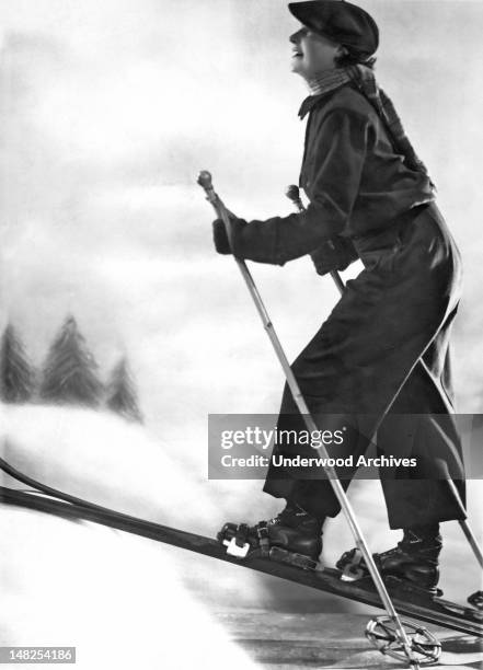 Woman cross country skiing in France, circa 1924.