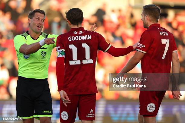 Referee Alex King talks with Craig Goodwin and Ryan Kitto of Adelaide following the half time whistle during the round 24 A-League Men's match...