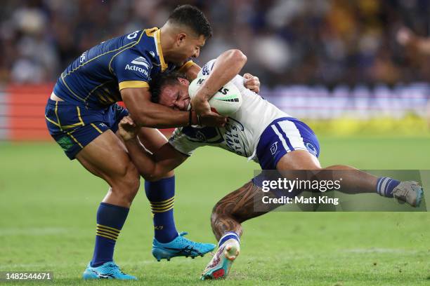 Jackson Topine of the Bulldogs is tackled by Will Penisini of the Eels during the round seven NRL match between Parramatta Eels and Canterbury...