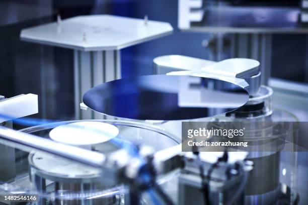 computer wafer on robotic arm at production line - wafer stock pictures, royalty-free photos & images
