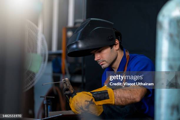 engineer working in steel metal,dealing with metal processing,worker in production line welding. - industriearbeider stockfoto's en -beelden