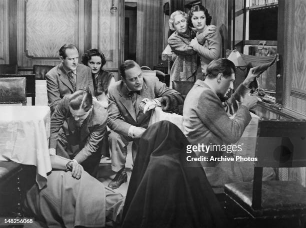 From left to right, Cecil Parker, Naunton Wayne , Linden Travers, Basil Radford, Dame May Whitty, Margaret Lockwood and Michael Redgrave are pinned...
