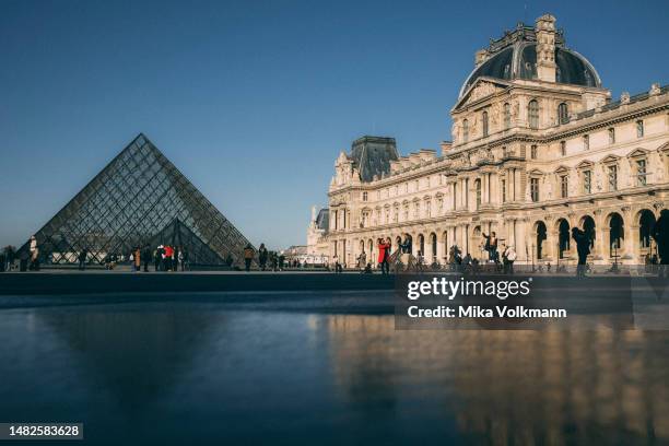 Glass pyramids in the courtyard of the Louvre, 2023 in Paris, France. Famous for its iconic landmarks, Paris is considered one of the most beautiful...