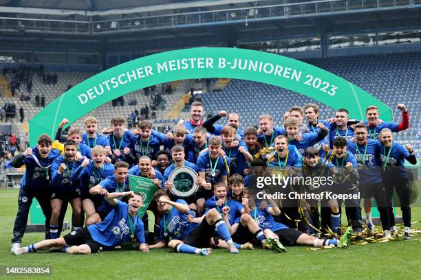 The team of Bielefeld celebrates with the trophy at the winnerboard after winning 2-1 the B Juniors German Championship Final between Arminia...