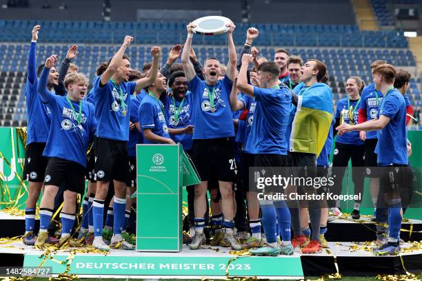 The team of Bielefeld celebrates with the trophy on the podium after winning 2-1 the B Juniors German Championship Final between Arminia Bielefeld...