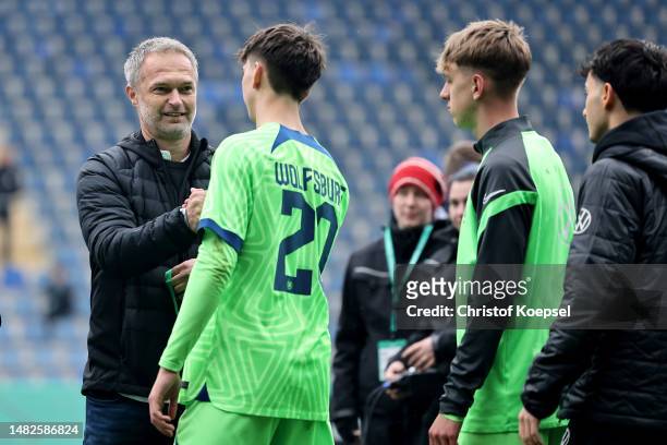 Christian Wueck, national coach U17 Germany hands out the silver medal to Louis Grobauer of Wolfsburg on the podium after the B Juniors German...