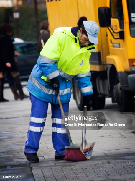 street sweeper woman working - sweeping sidewalk stock pictures, royalty-free photos & images