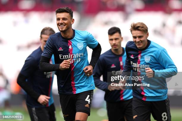 Ben White and Martin Odegaard of Arsenal warm up prior to the Premier League match between West Ham United and Arsenal FC at London Stadium on April...