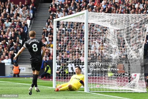 Martin Odegaard of Arsenal scores the team's second goal during the Premier League match between West Ham United and Arsenal FC at London Stadium on...