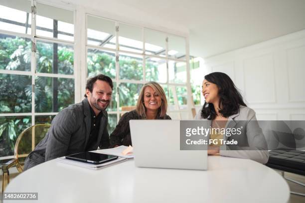 real estate agent talking to a couple in a house - home loans stock pictures, royalty-free photos & images