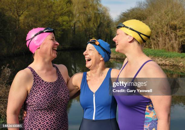 group of female open water swimmers - cold stock pictures, royalty-free photos & images