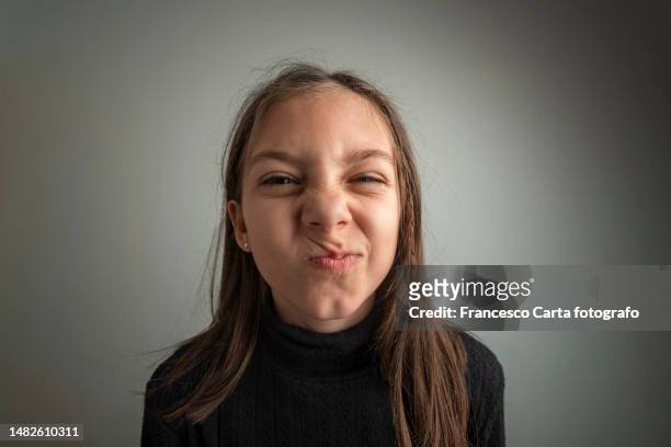 young girl pulling silly faces - fisheye stock pictures, royalty-free photos & images