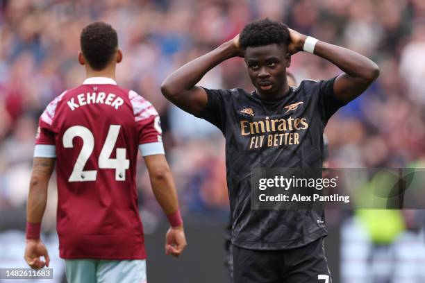 Bukayo Saka of Arsenal reacts after missing a penalty during the Premier League match between West Ham United and Arsenal FC at London Stadium on...