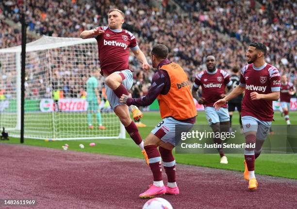 Jarrod Bowen of West Ham United celebrates with Danny Ings and teammates after scoring the team's second goal during the Premier League match between...