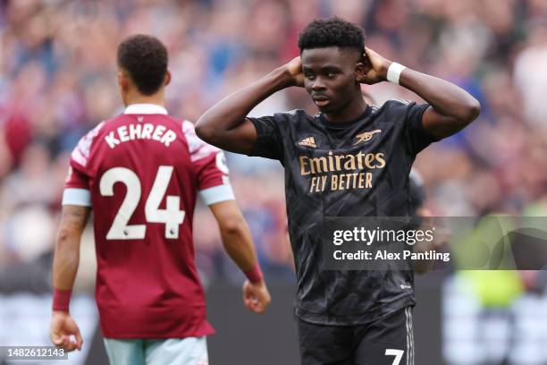 Bukayo Saka of Arsenal reacts after missing a penalty during the Premier League match between West Ham United and Arsenal FC at London Stadium on...