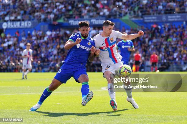 Omar Alderete of Getafe CF and Robert Lewandowski of FC Barcelona battle for the ball during the LaLiga Santander match between Getafe CF and FC...