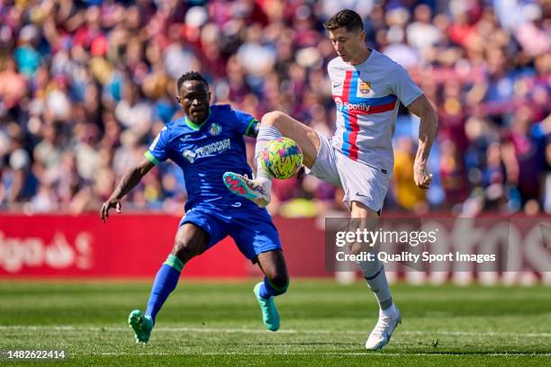 Djene Dakonam of Getafe CF battle for the ball with Robert Lewandowski of FC Barcelona during the LaLiga Santander match between Getafe CF and FC...