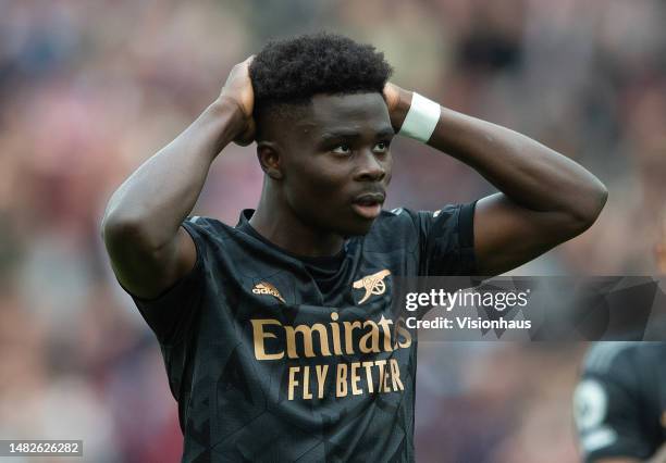Bukayo Saka of Arsenal reacts after missing a penalty during the Premier League match between West Ham United and Arsenal FC at London Stadium on...