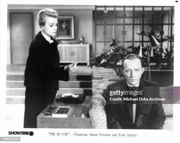 Inger Stevens gesturing near Bing Crosby in a scene from the film 'Man On Fire', 1957.