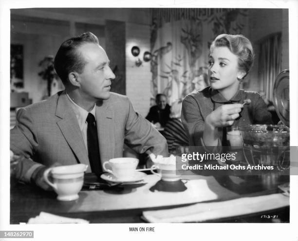 Bing Crosby having conversation with Inger Stevens over coffee in a scene from the film 'Man On Fire', 1957.