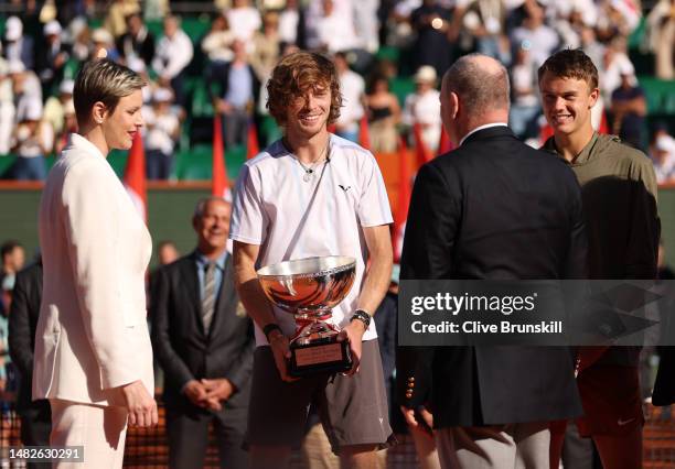 Andrey Rublev holds the winners trophy as he speaks with Prince Albert II and Princess Charlene after his three set victory against Holger Rune of...