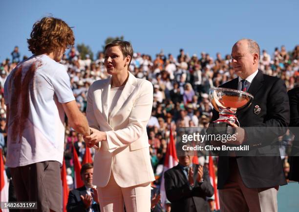 Andrey Rublev speaks with Princess Charlene before receiving the winners trophy from Prince Albert II after his three set victory against Holger Rune...