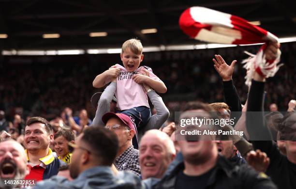 Young Arsenal fans celebrates a goal during the Premier League match between West Ham United and Arsenal FC at London Stadium on April 16, 2023 in...