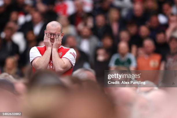 An Arsenal supporter shows their frustration during the Premier League match between West Ham United and Arsenal FC at London Stadium on April 16,...