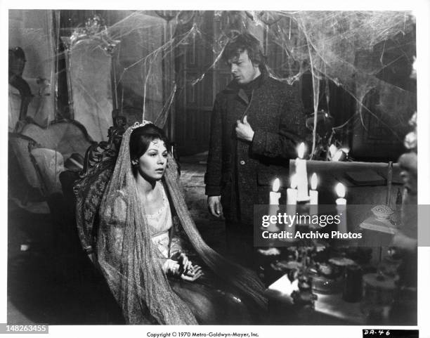 Woman sitting with John Karlen in the background in a scene from the film 'Night Of Dark Shadows', 1971.