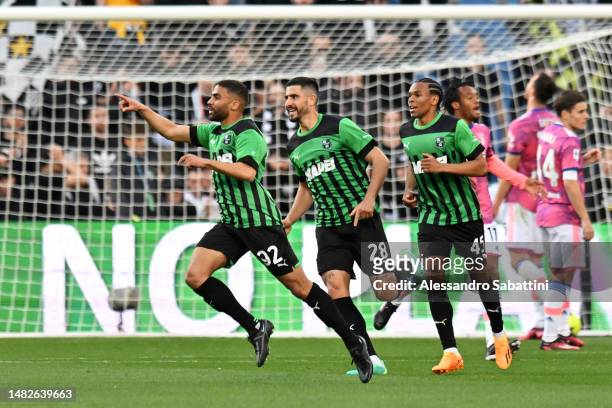 Gregoire Defrel of US Sassuolo celebrates with teammates Martin Erlic and Armand Lauriente after scoring the team's first goal during the Serie A...