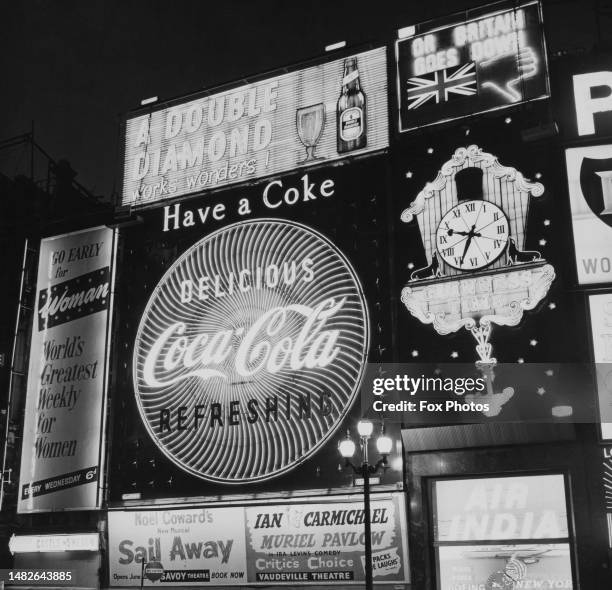 Illuminated advertising - including ads for 'Woman' magazine, 'Double Diamond' beer and 'Coca Cola' - in Piccadilly Circus in London, England, May...