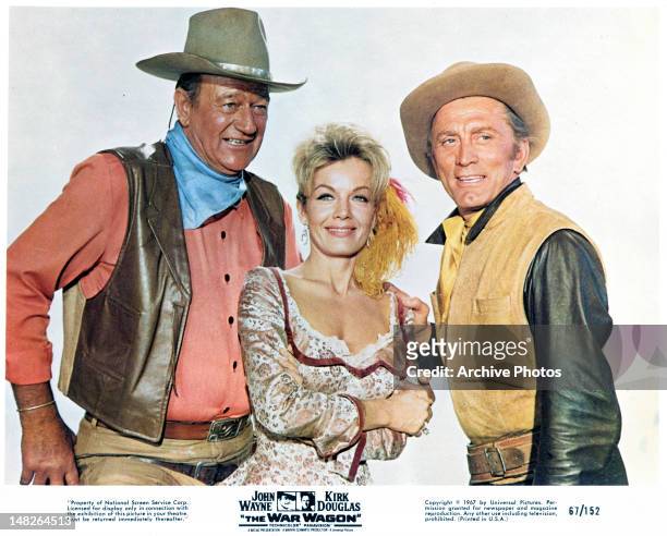 John Wayne, Joanna Barnes, and Kirk Douglas publicity portrait for the film 'The War Wagon', 1967.