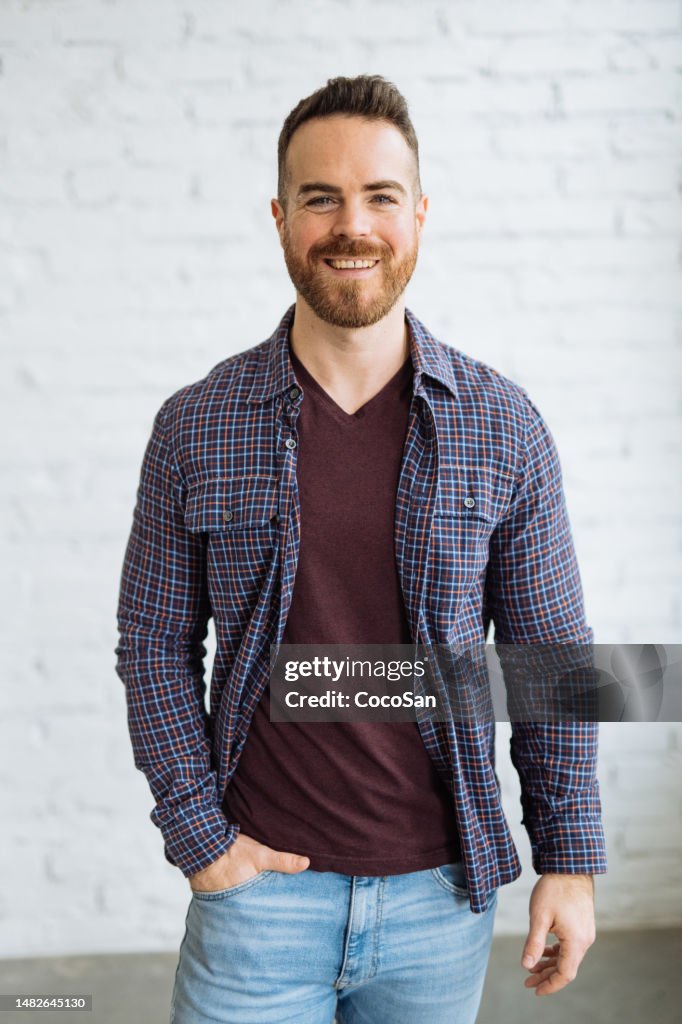 Portrait of handsome muscular bearded man looking at camera