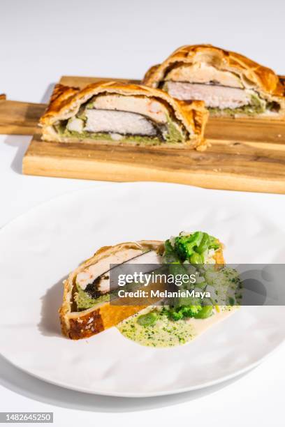 french pastry pie with chicken filet and broccoli at michelin star gourmet restaurant - food design stock pictures, royalty-free photos & images