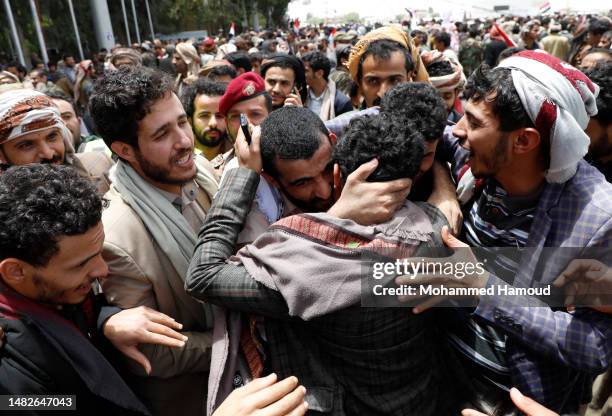 Yemeni conflict detainee is hugged by his relatives after he was freed in a prisoner exchange between warring sides at the Sana'a International...