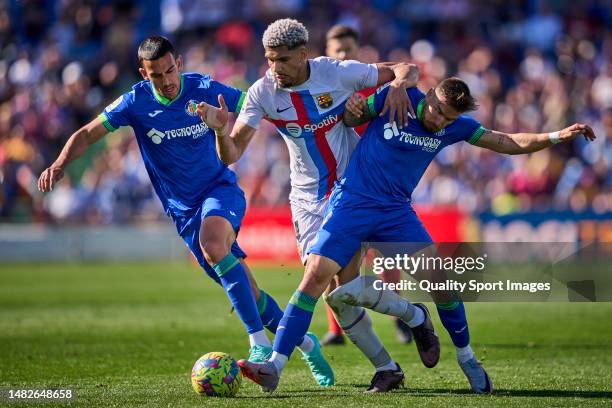 Portu of Getafe CF battle for the ball with Ronald Araujo of FC Barcelona during the LaLiga Santander match between Getafe CF and FC Barcelona at...