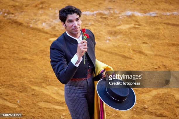 Spanish matador Cayetano Rivera holds one of the bull ears trophy as he ackowledges the spectators during the GranaDown bullfight festival at the...