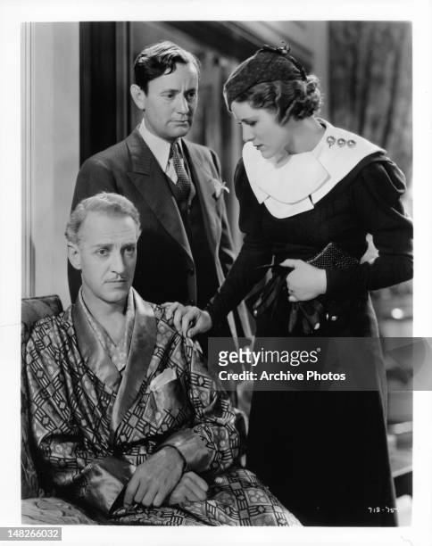 Otto Kruger has blank stare with Roscoe Karns and Irene Hervey standing beside him in a scene from the film 'The Women In His Life', 1933.