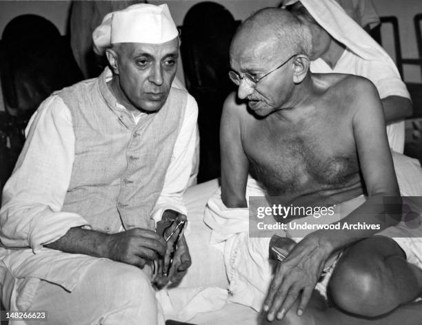 Jawaharlal Nehru, the newly elected President of the All India Congress, talking with Mahatma Gandhi, Indian political strong man, at a meeting of...