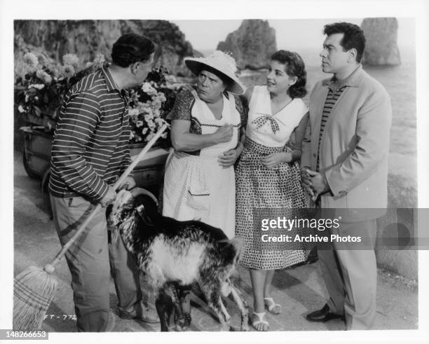 Hans Söhnker rebukes Annie Rosar in front of Johanna von Koczian and Mario Lanza for chasing down a goat that has eaten up her flowers in a scene...