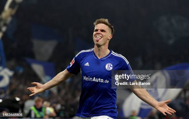 Marius Buelter of Schalke celebrates after scoring his teams fourth goal during the Bundesliga match between FC Schalke 04 and Hertha BSC at...