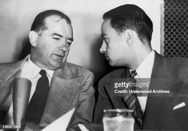 Senator Joseph McCarthy chats with his attorney Roy Cohn during Senate Subcommittee hearings on the Army-McCarthy dispute, Washington DC, 1954.