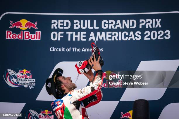 Alex Rins of Spain and LCR Honda Castrol drinks Prosecco out of his boots during the Race of the MotoGP Red Bull Grand Prix of The Americas at...