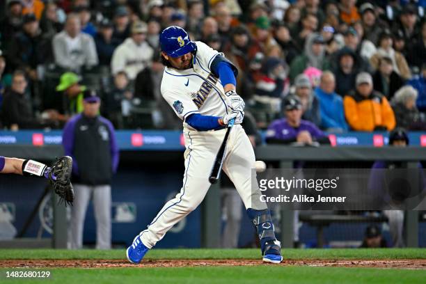 Eugenio Suarez of the Seattle Mariners hits a single during the fourth inning against the Colorado Rockies at T-Mobile Park on April 16, 2023 in...