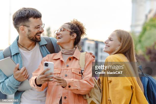 young people using smart phone on the street - group of people on phones stock pictures, royalty-free photos & images