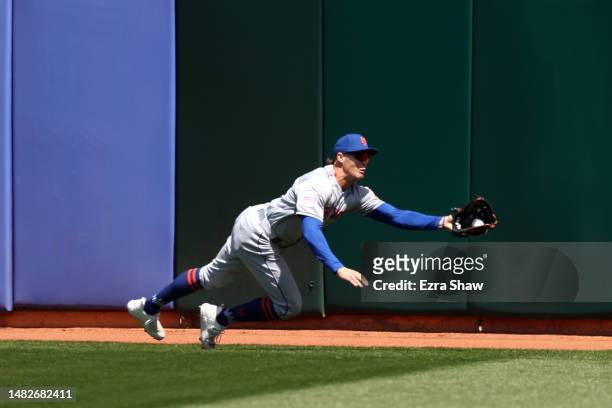 Brandon Nimmo of the New York Mets catches a ball hit by Aledmys Diaz of the Oakland Athletics in the second inning at RingCentral Coliseum on April...