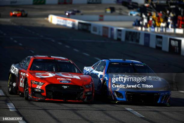 Joey Logano, driver of the Verizon 5G Ford, and Kyle Larson, driver of the HendrickCars.com Chevrolet, race during the NASCAR Cup Series NOCO 400 at...